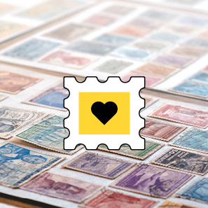 Stilistische Briefmarke mit Herzbild vor einem Tisch voller alter Sammlerbriefmarken.
